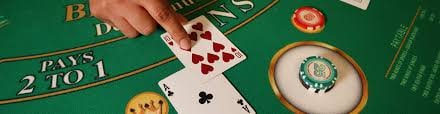 Close-up of professional live dealer shuffling cards at keraton bola Bali Vacation table